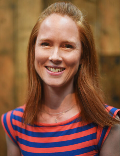 A headshot image of Suzanne Jones smiling towards the camera.